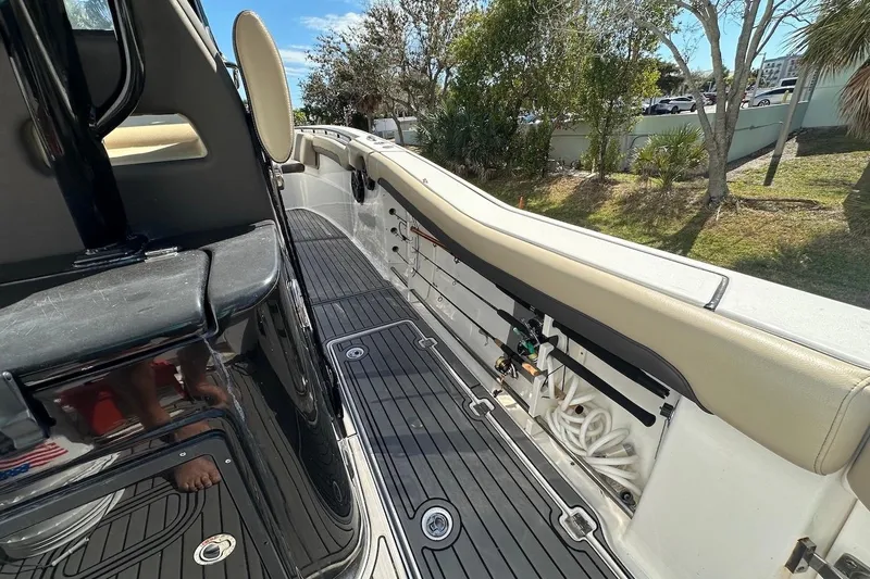 Slide: The Image of 2018 Tidewater 320 CC Adventure boat interior with seating and deck details. - 15