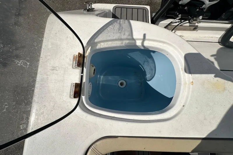 Slide: The Image of 2018 Tidewater 320 CC Adventure boat livewell, open lid, showing interior. - 21