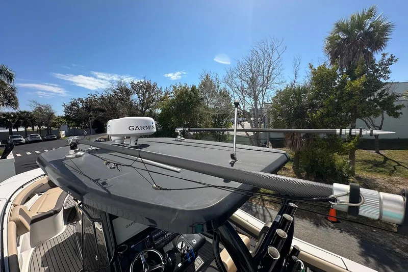 Slide: The Image of 2018 Tidewater 320 CC Adventure boat with Garmin radar, sunny day, palm trees in background. - 23