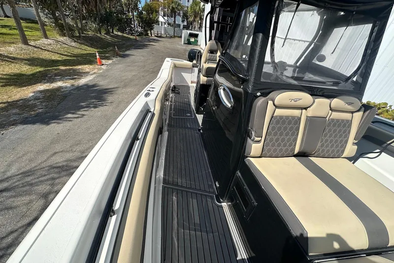 Slide: The Image of 2018 Tidewater 320 CC Adventure boat interior with seating and walkway. - 6