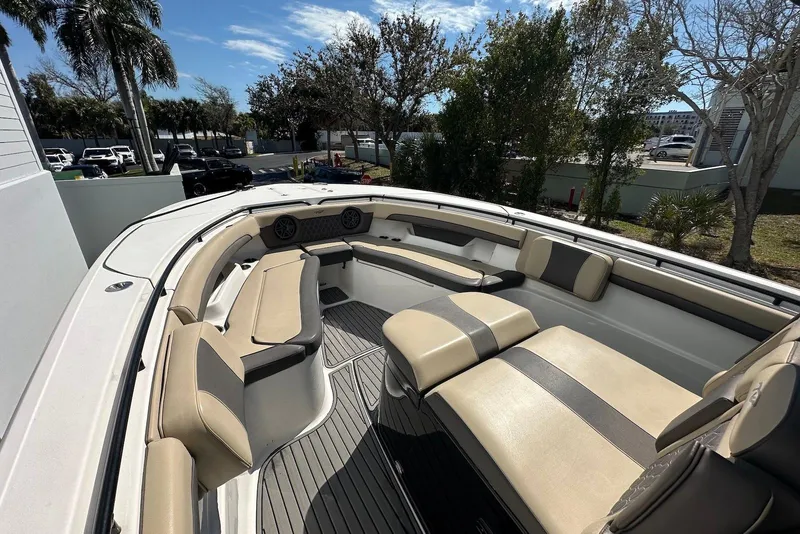 Slide: The Image of 2018 Tidewater 320 CC Adventure boat interior with beige seating and spacious layout. - 8