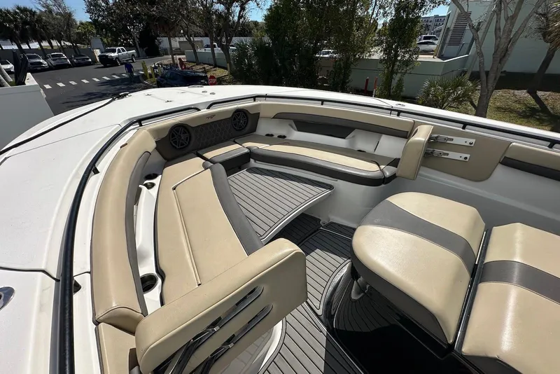 Slide: The Image of 2018 Tidewater 320 CC Adventure boat interior with beige seating and modern design. - 9