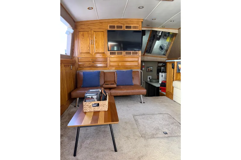 Slide: The Image of Interior of 1984 Bertram 42 Convertible yacht with wood cabinetry and modern seating. - 14