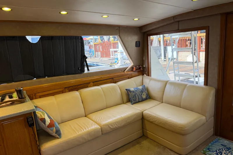 Slide: The Image of Interior of 1984 Bertram 42 Convertible yacht with cream leather sofa and decorative pillows. - 15
