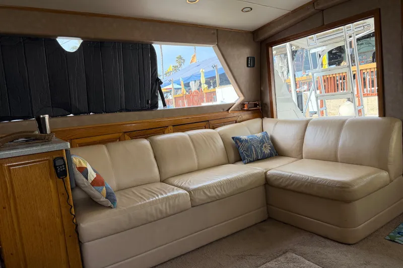 Slide: The Image of Interior of 1984 Bertram 42 Convertible yacht with beige leather sofa and decorative pillows. - 16