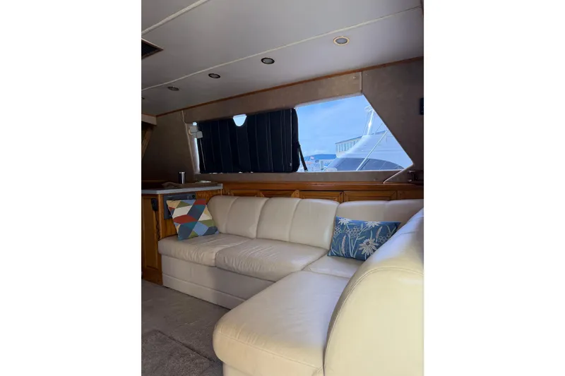 Slide: The Image of Interior of 1984 Bertram 42 Convertible yacht with white leather sofa and decorative pillows. - 17