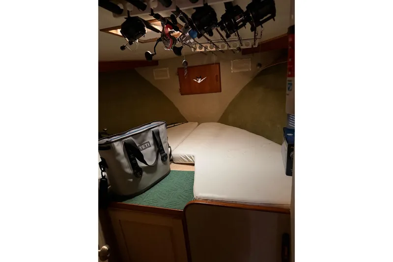 Slide: The Image of Cozy cabin interior of 1984 Bertram 42 Convertible with fishing rods and gear. - 23