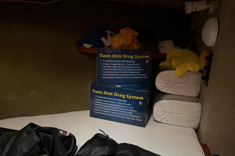 Slide: The Image of Storage area in a 1984 Bertram 42 Convertible with Twin Disk Drag System boxes. - 25