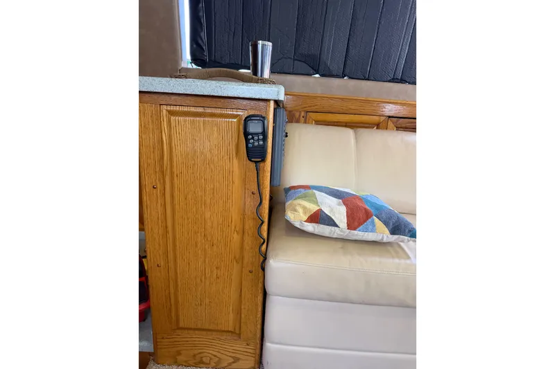 Slide: The Image of Interior of 1984 Bertram 42 Convertible with wood cabinet, radio, and colorful pillow. - 30