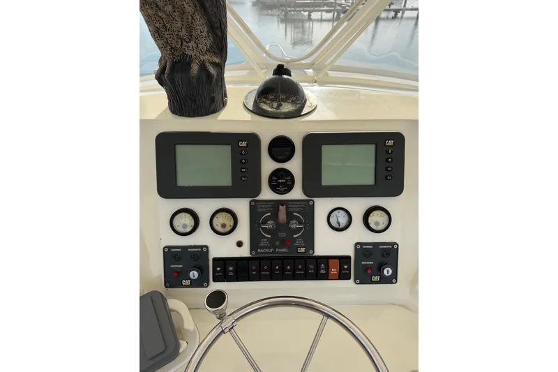 Slide: The Image of Control panel of a 1984 Bertram 42 Convertible boat with gauges and displays. - 5