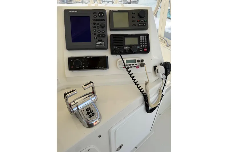 Slide: The Image of Control panel of a 1984 Bertram 42 Convertible boat with navigation and communication equipment. - 7
