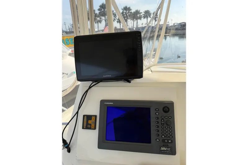 Slide: The Image of Garmin and Furuno navigation systems on a 1984 Bertram 42 Convertible boat. - 9