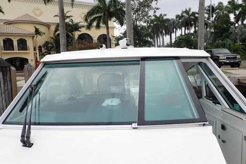 Slide: The Image of 2023 Formula 380 Super Sport Crossover OB boat docked near palm trees. - 26