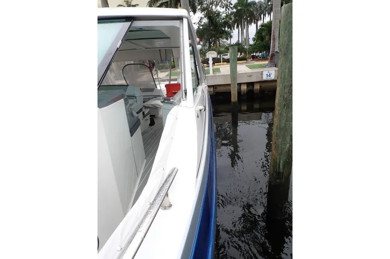 Slide: The Image of 2023 Formula 380 Super Sport Crossover OB docked near palm trees. - 28