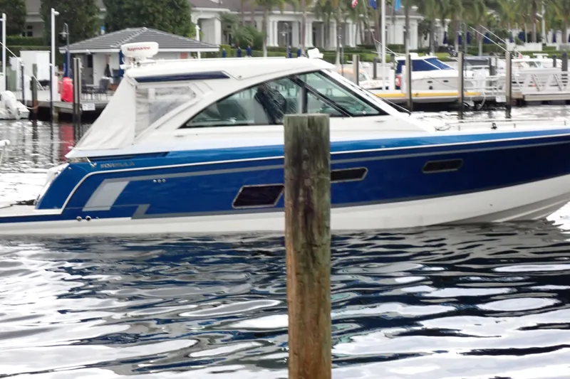 Slide: The Image of 2023 Formula 380 Super Sport Crossover OB boat docked in marina. - 3