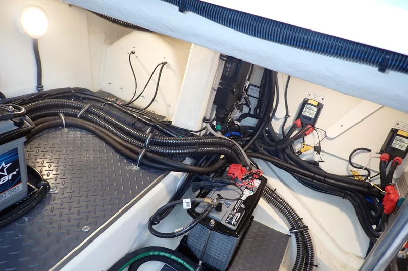 Slide: The Image of Engine compartment of 2023 Formula 380 Super Sport Crossover OB with wiring and battery setup. - 37
