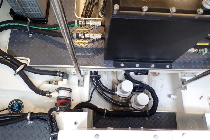 Slide: The Image of Engine compartment of 2023 Formula 380 Super Sport Crossover OB with visible hoses and components. - 39