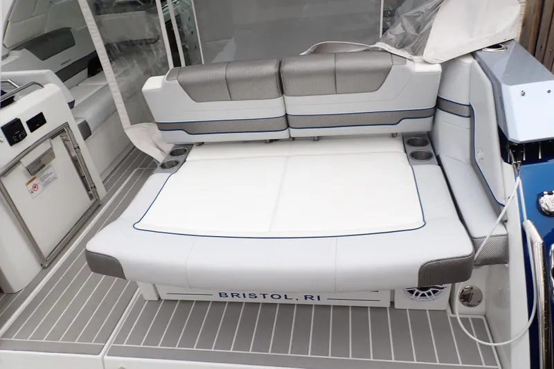 Slide: The Image of 2023 Formula 380 Super Sport Crossover OB boat seating area, featuring modern design and cup holders. - 47