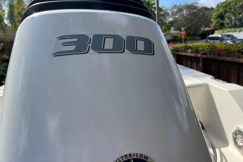 Slide: The Image of Outboard motor on 1999 Pursuit 2470 Walkaround boat, featuring "300" horsepower label. - 11