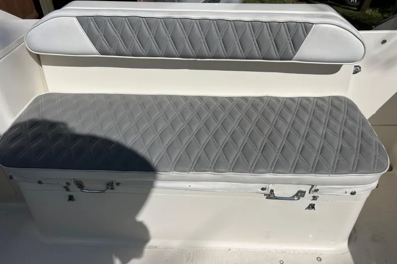 Slide: The Image of 1999 Pursuit 2470 Walkaround boat seat with gray diamond-stitched upholstery. - 14