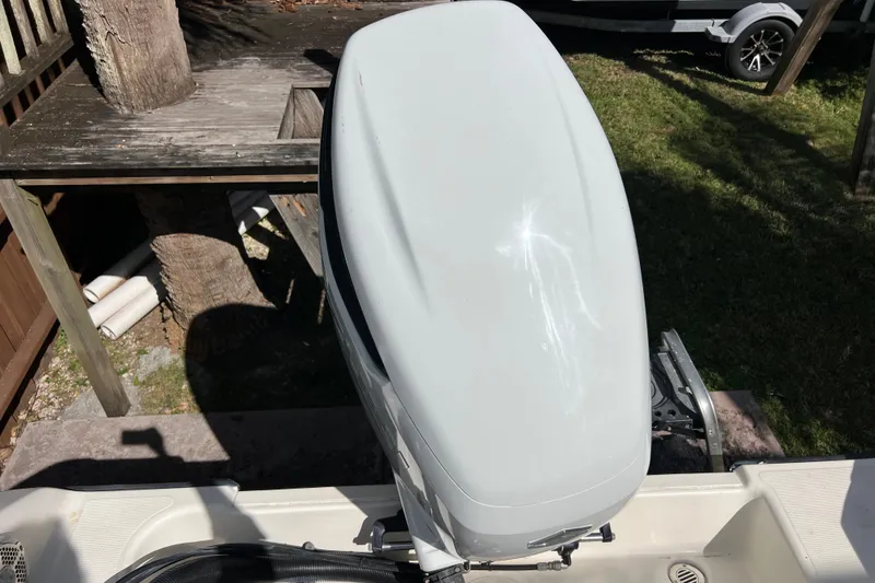 Slide: The Image of 1999 Pursuit 2470 Walkaround boat engine cover in outdoor setting. - 16