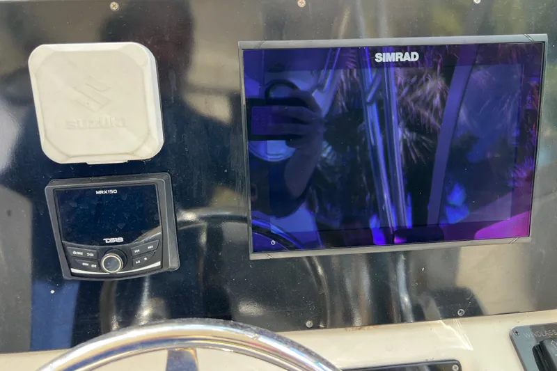 Slide: The Image of Control panel of a 1999 Pursuit 2470 Walkaround boat with Simrad display. - 17