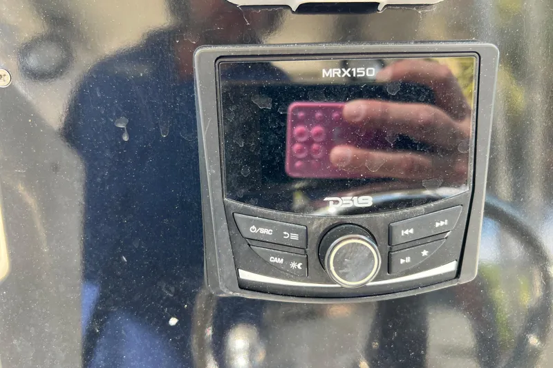 Slide: The Image of Close-up of a DS18 MRX150 marine stereo on a 1999 Pursuit 2470 Walkaround boat. - 18