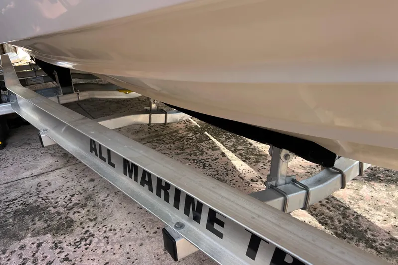 Slide: The Image of 1999 Pursuit 2470 Walkaround boat on All Marine trailer, close-up view. - 7