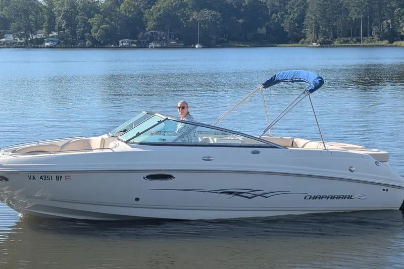 Slide: The Image of 2008 Chaparral 246 SSi boat on a calm lake with trees in the background. - 0