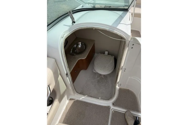 Slide: The Image of 2008 Chaparral 246 SSi boat interior with compact bathroom and sink. - 10