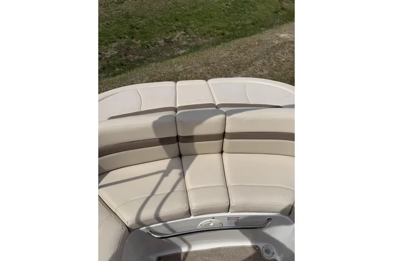 Slide: The Image of 2008 Chaparral 246 SSi boat with beige seating and outdoor view. - 12