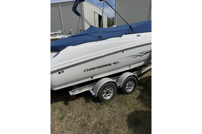 Slide: The Image of 2008 Chaparral 246 SSi boat on trailer with blue cover, parked on grass. - 13