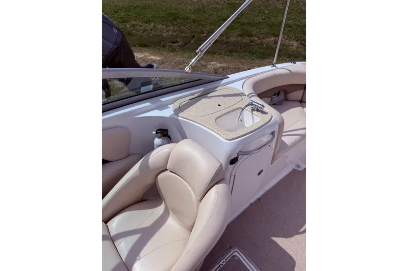 Slide: The Image of 2008 Chaparral 246 SSi boat interior with beige seating and a small sink. - 6
