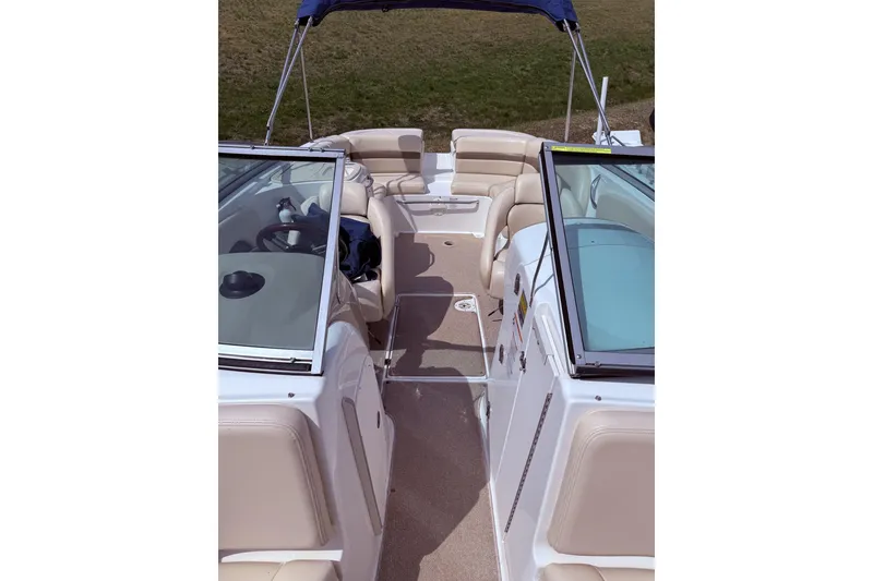 Slide: The Image of 2008 Chaparral 246 SSi boat interior with beige seating and blue canopy. - 9