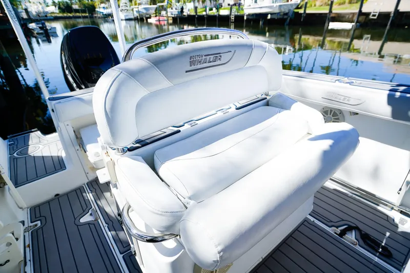 Slide: The Image of 2004 Boston Whaler 240 Outrage boat interior with white seating and sleek design. - 15