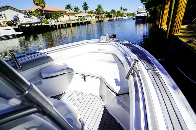 Slide: The Image of 2004 Boston Whaler 240 Outrage boat docked in a scenic canal setting. - 22