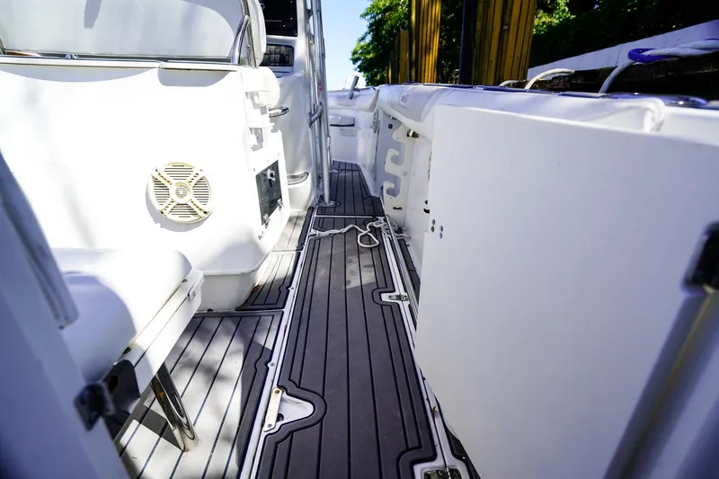 Slide: The Image of 2004 Boston Whaler 240 Outrage interior with sleek deck and seating. - 7
