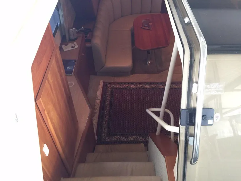 Slide: The Image of Interior of 1998 Silverton 372 Motor Yacht, featuring stairs and seating area. - 19