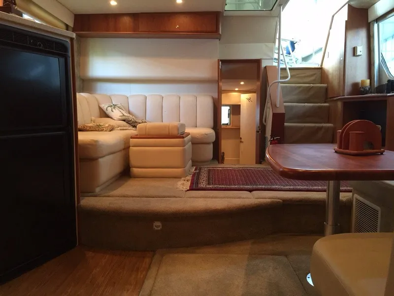 Slide: The Image of Interior of 1998 Silverton 372 Motor Yacht, featuring cozy seating area. - 24