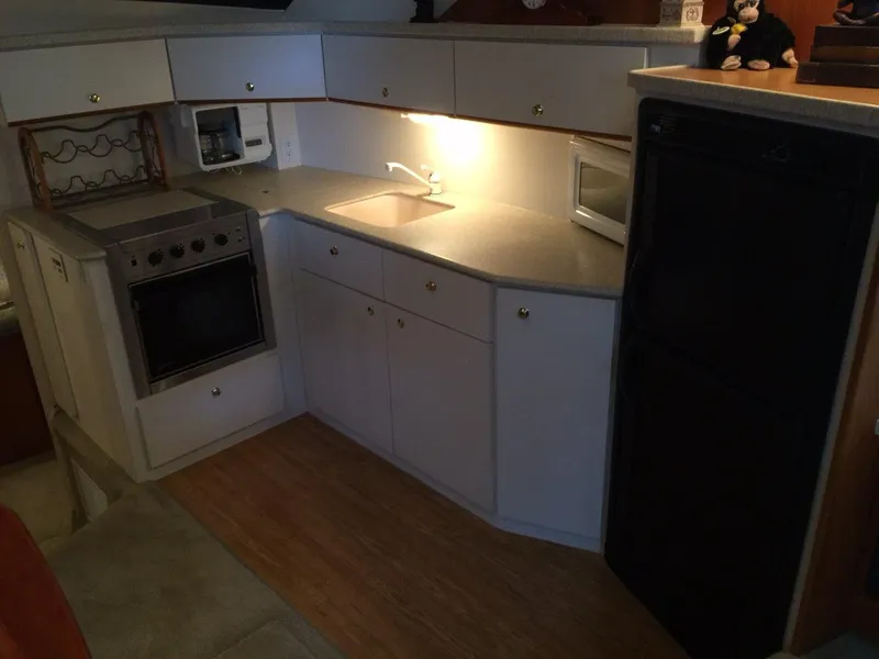 Slide: The Image of Interior of 1998 Silverton 372 Motor Yacht, kitchen with stove and sink. - 27
