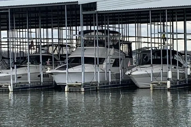 Slide: The Image of 1998 Silverton 372 Motor Yacht docked in a marina, surrounded by other boats. - 36