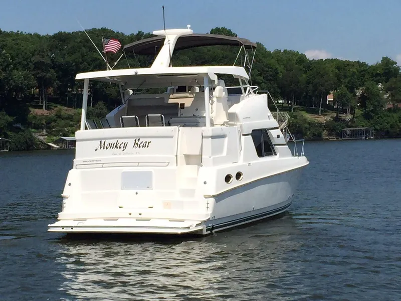 Slide: The Image of 1998 Silverton 372 Motor Yacht on a serene lake. - 4