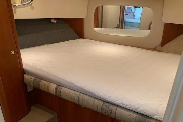 Slide: The Image of 1998 Silverton 372 Motor Yacht cabin with a comfortable bed and wooden interior. - 40