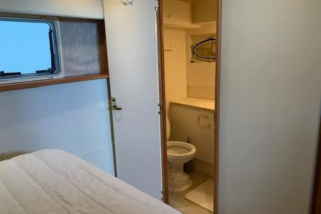 Slide: The Image of 1998 Silverton 372 Motor Yacht interior with bedroom and bathroom view. - 43