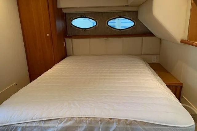 Slide: The Image of 1998 Silverton 372 Motor Yacht bedroom with double bed and porthole windows. - 44