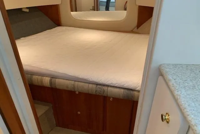 Slide: The Image of Interior cabin of 1998 Silverton 372 Motor Yacht with cozy bed and wooden accents. - 46