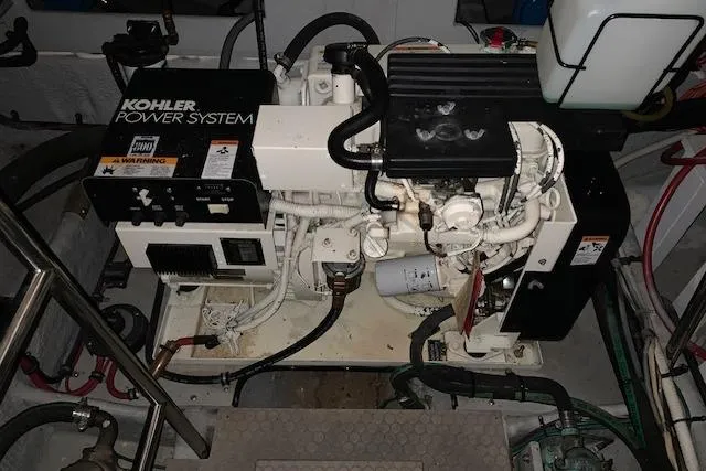 Slide: The Image of Engine room of a 1998 Silverton 372 Motor Yacht featuring a Kohler power system. - 47