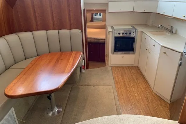Slide: The Image of 1998 Silverton 372 Motor Yacht interior with dining area and kitchen. - 48