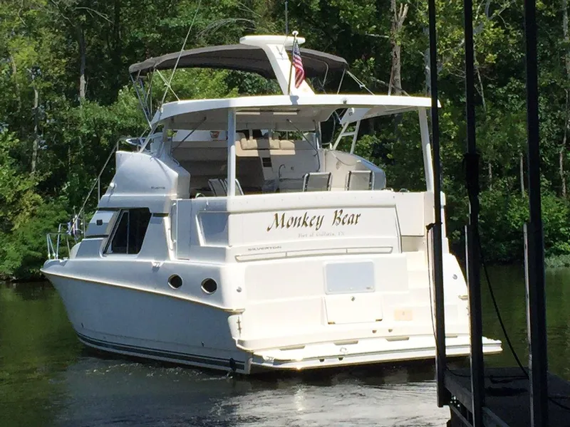 Slide: The Image of 1998 Silverton 372 Motor Yacht on a river. - 6