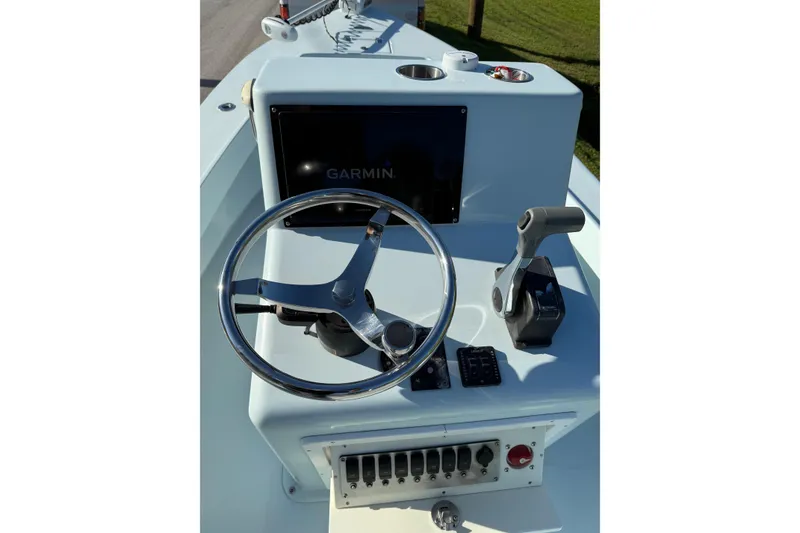 Slide: The Image of 2017 Sabalo 22 boat dashboard with steering wheel and Garmin display. - 12